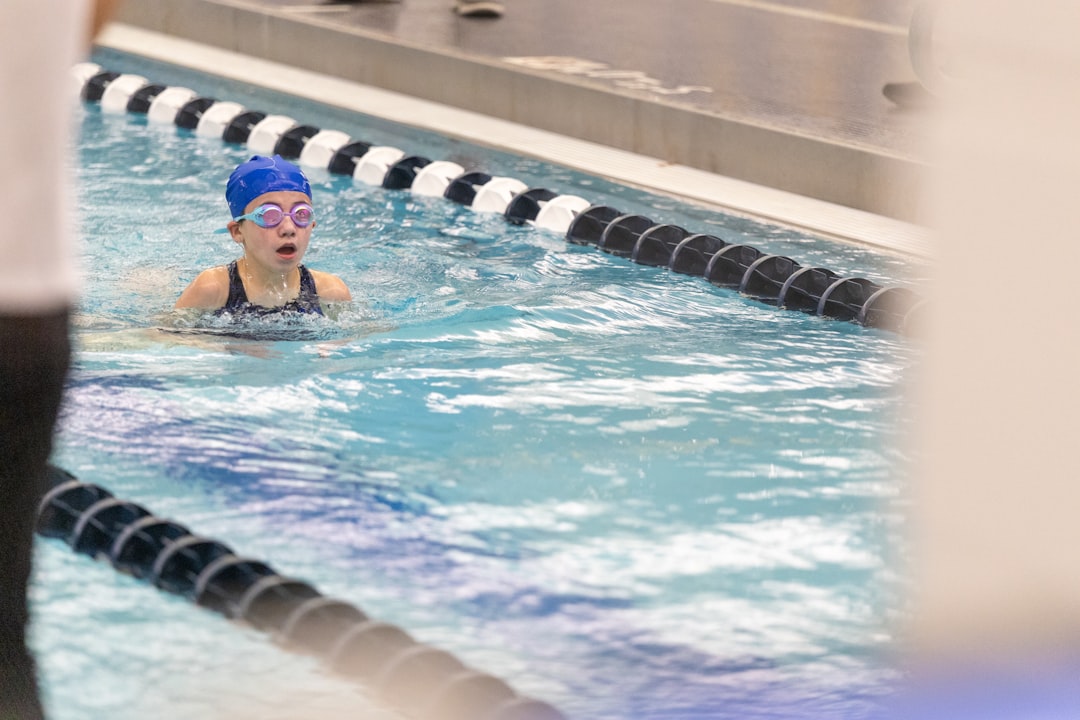 a-girl-swimming-in-a-pool-wearing-a-swimming-cap-a-8sophmmls