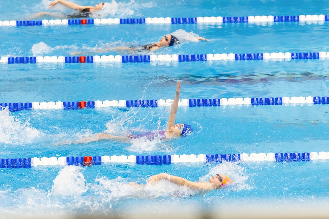 a-group-of-people-swimming-in-a-pool-9ob319caowu
